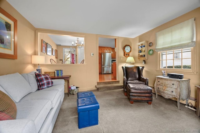 carpeted living room featuring a chandelier