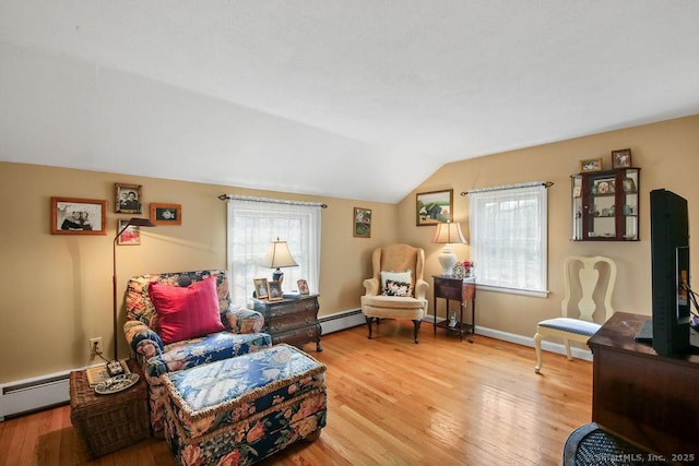 living area featuring baseboards, baseboard heating, wood finished floors, and vaulted ceiling