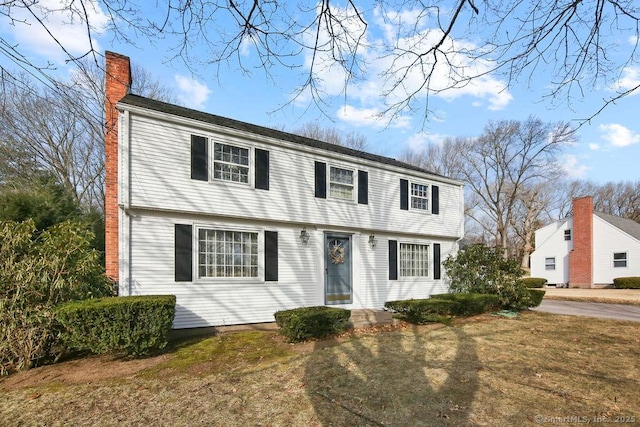 colonial inspired home with a chimney