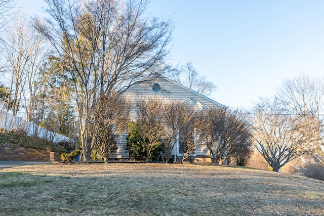 view of home's exterior featuring a yard and fence