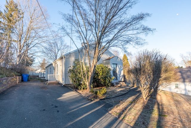 view of home's exterior with fence