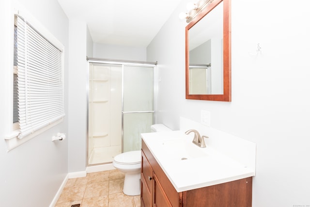 bathroom featuring baseboards, toilet, a stall shower, and vanity