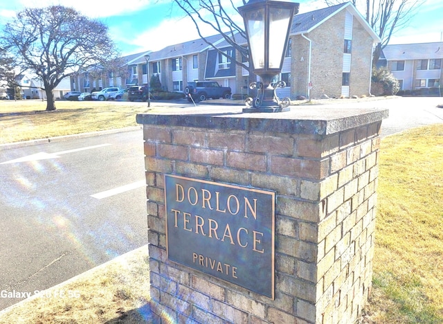 community / neighborhood sign featuring a residential view