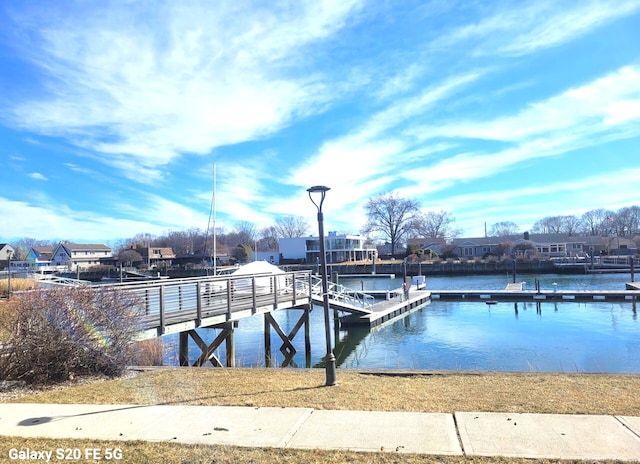 dock area with a residential view and a water view