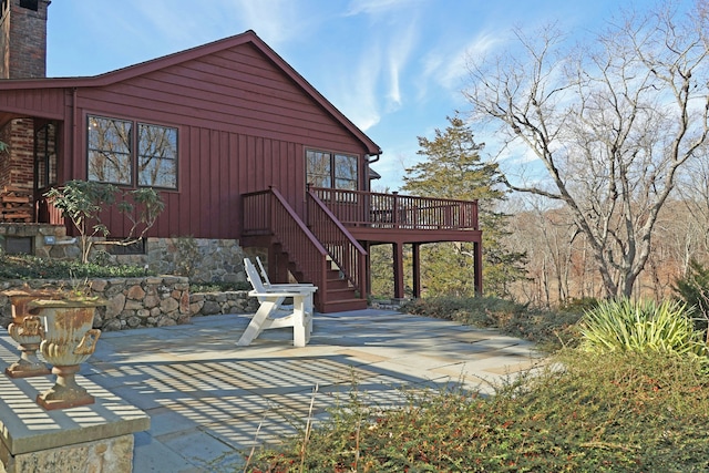 back of house featuring a patio and a deck