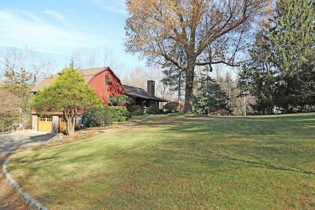 view of yard with an attached garage and driveway