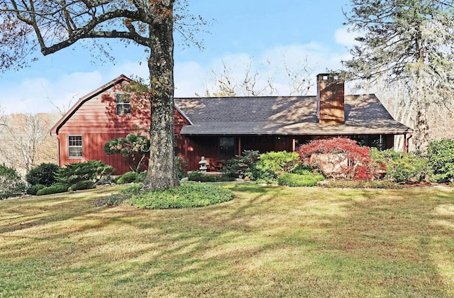 rear view of house with a yard and a chimney