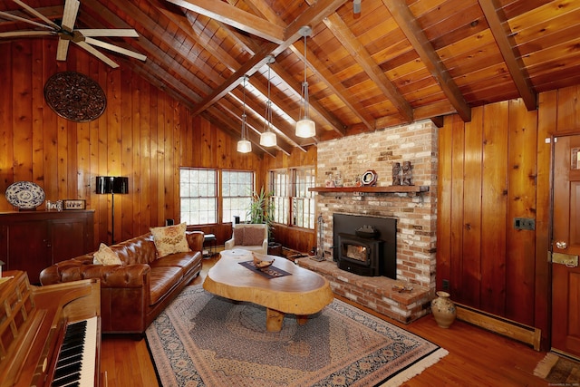 living room featuring a baseboard heating unit, wooden ceiling, wooden walls, and wood finished floors