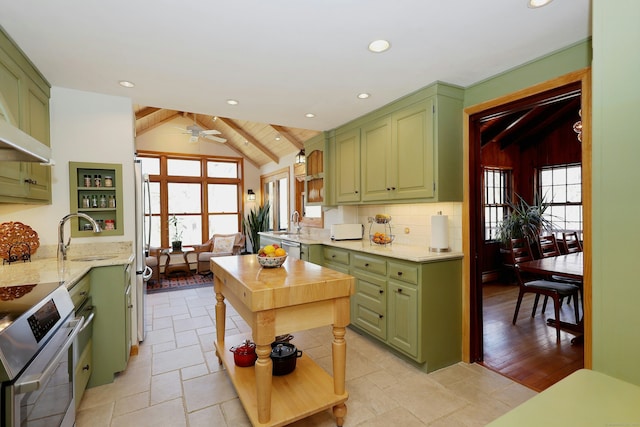 kitchen with a sink, stainless steel appliances, and green cabinets