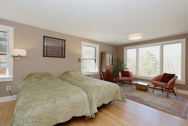 bedroom featuring wood finished floors and baseboards