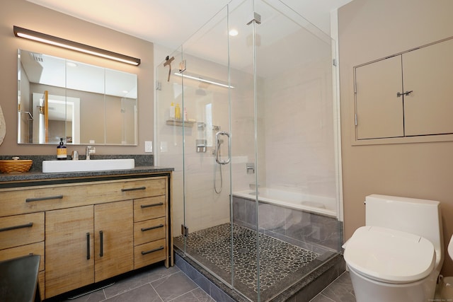 full bathroom featuring a shower stall, vanity, and toilet