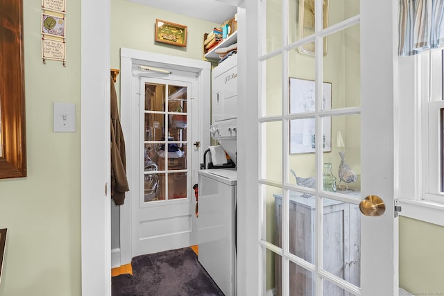 interior space with stacked washing maching and dryer