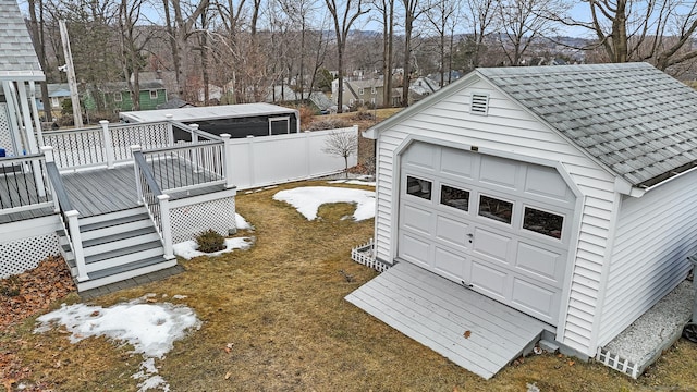 view of yard featuring an outbuilding, a deck, and fence