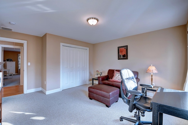 office space featuring carpet, visible vents, and baseboards