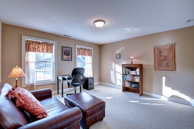 carpeted living area with visible vents and baseboards