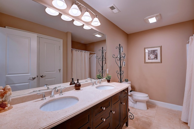 bathroom with tile patterned floors, toilet, visible vents, and a sink