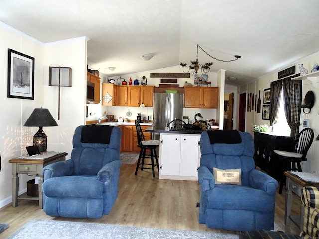 living area featuring light wood-style flooring, crown molding, and lofted ceiling