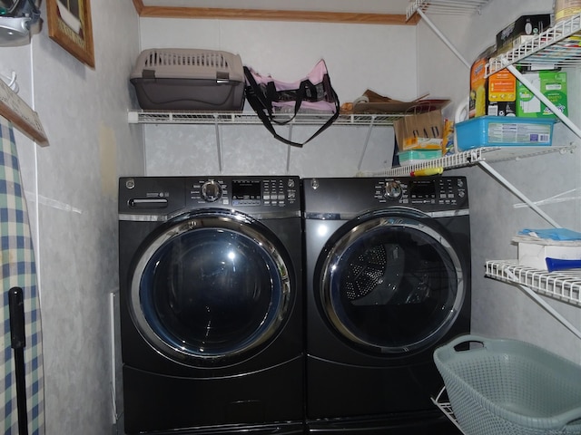 clothes washing area with laundry area and washer and dryer