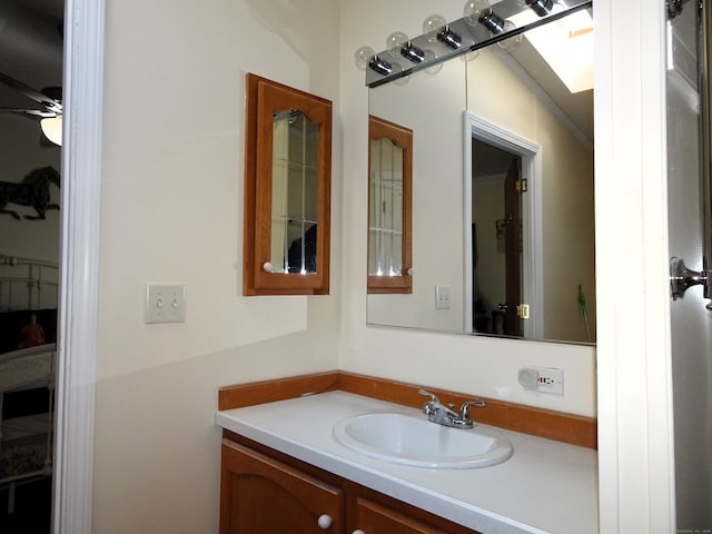 bathroom featuring ceiling fan and vanity