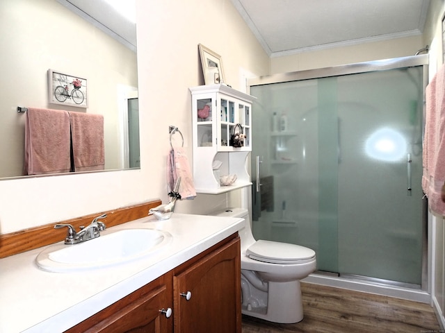 full bath with vanity, a shower stall, wood finished floors, and ornamental molding