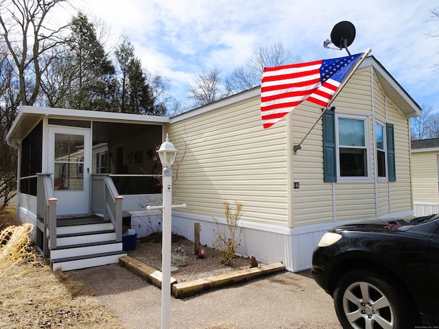 view of side of home featuring a sunroom