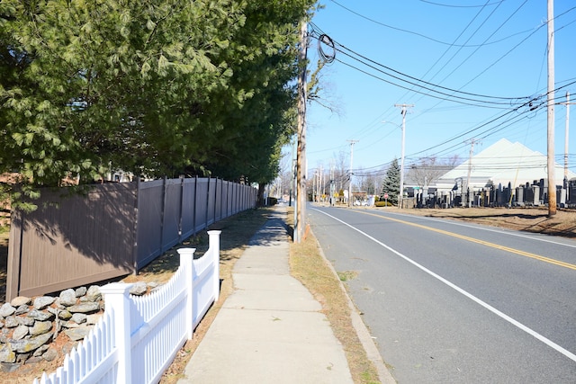 view of road featuring sidewalks and street lighting