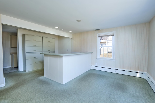 interior space with a peninsula, recessed lighting, light countertops, light carpet, and baseboard heating