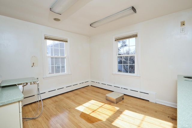 spare room with a wealth of natural light and light wood-style floors