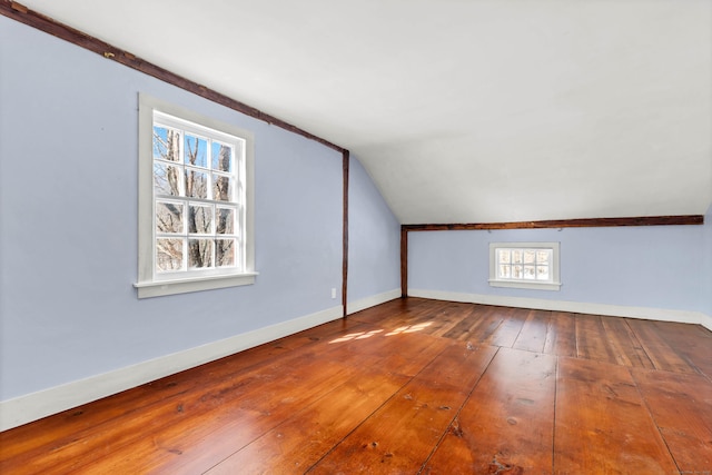 bonus room featuring baseboards, lofted ceiling, and hardwood / wood-style floors