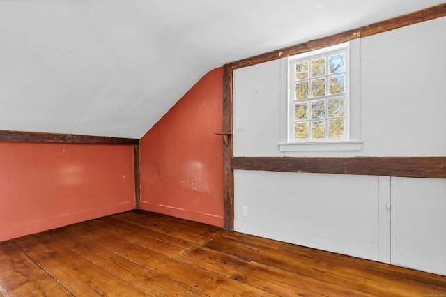 bonus room with hardwood / wood-style flooring and lofted ceiling