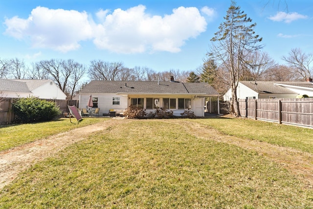 back of property featuring a yard and a fenced backyard