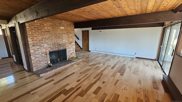 unfurnished living room featuring a fireplace, light wood-style floors, a baseboard heating unit, wooden ceiling, and beamed ceiling