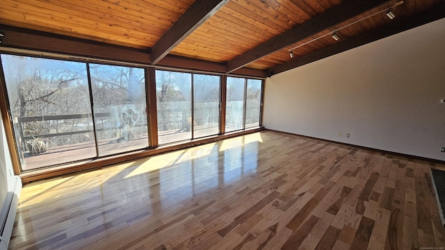 interior space with beamed ceiling, wood finished floors, and wooden ceiling