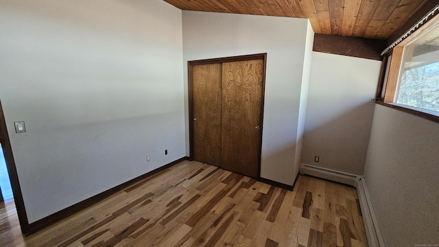 unfurnished bedroom with a baseboard radiator, wood ceiling, lofted ceiling, and wood finished floors