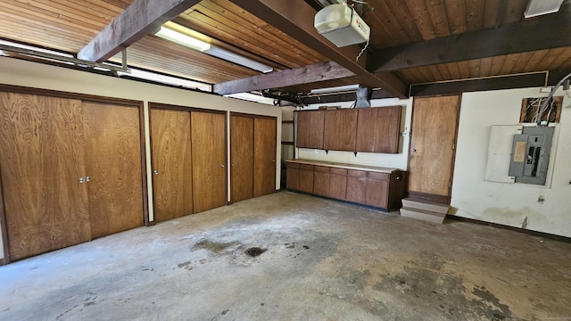 below grade area featuring electric panel and a garage