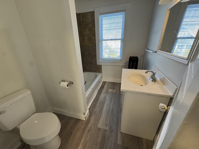 full bathroom featuring baseboards, toilet, wood finished floors, and vanity