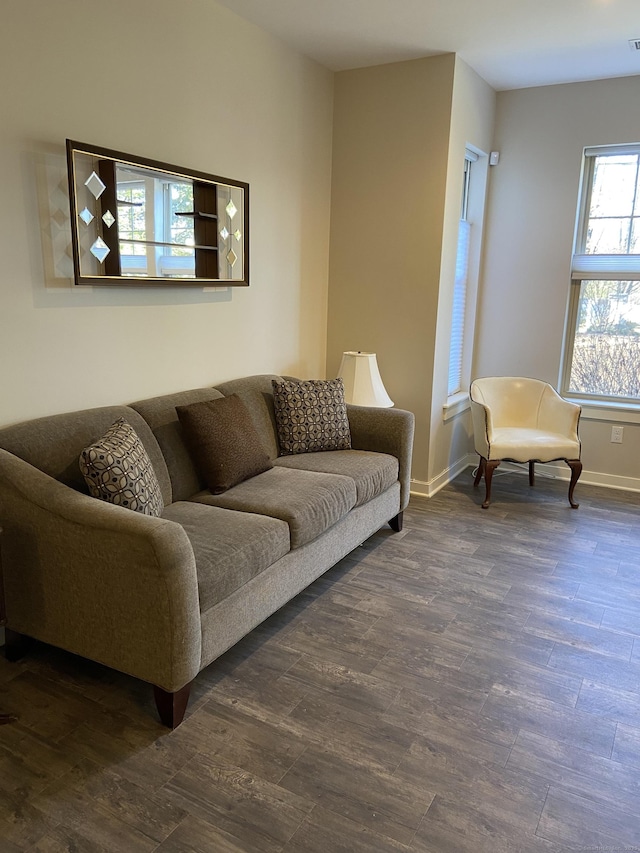 living area featuring dark wood finished floors and baseboards