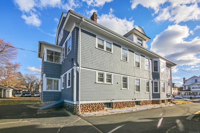 exterior space with a residential view and a chimney