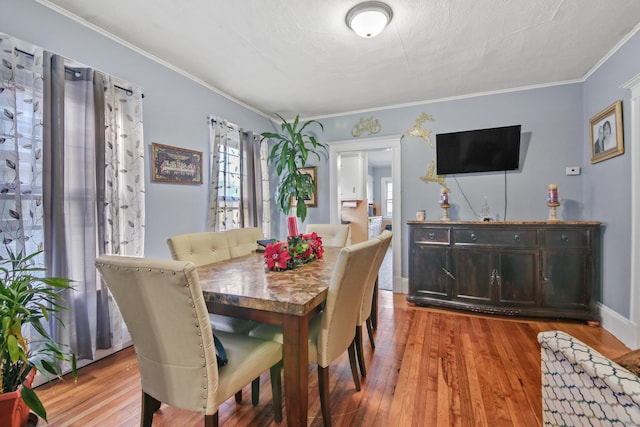 dining room featuring crown molding and wood-type flooring