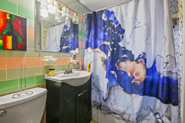 full bathroom with decorative backsplash, tile walls, curtained shower, and vanity