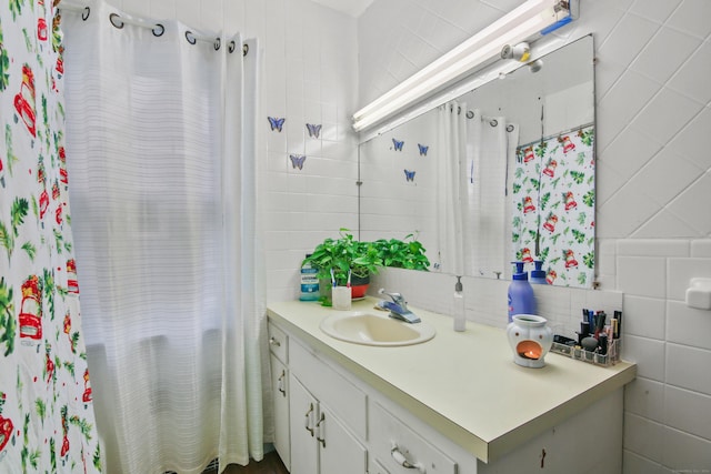 full bathroom with backsplash, tile walls, and vanity