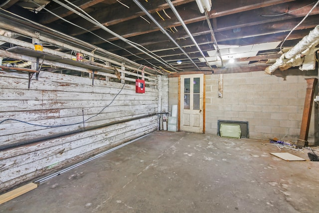 unfinished basement with concrete block wall