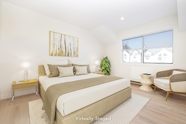 bedroom with recessed lighting, baseboards, baseboard heating, and light wood finished floors