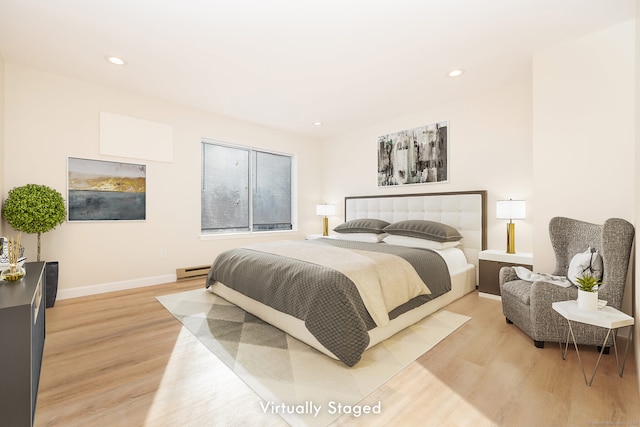 bedroom featuring a baseboard heating unit, recessed lighting, light wood-style floors, and baseboards