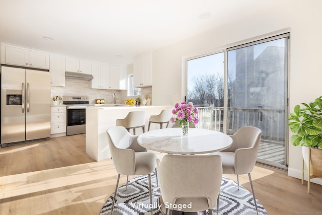 dining area featuring light wood finished floors