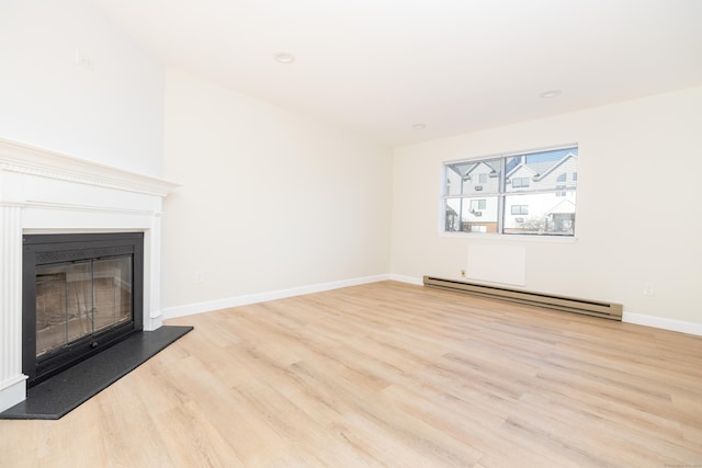 unfurnished living room with a glass covered fireplace, wood finished floors, baseboards, and a baseboard radiator