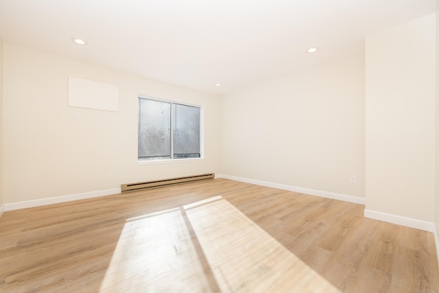 spare room featuring recessed lighting, light wood-style floors, baseboards, and baseboard heating