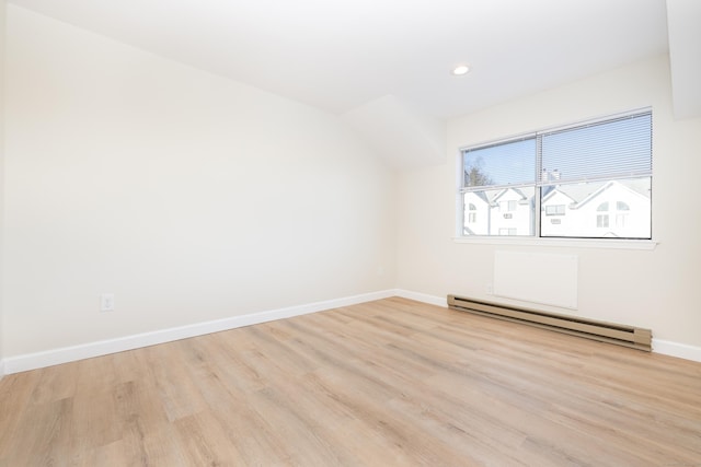 spare room featuring recessed lighting, baseboards, baseboard heating, and wood finished floors