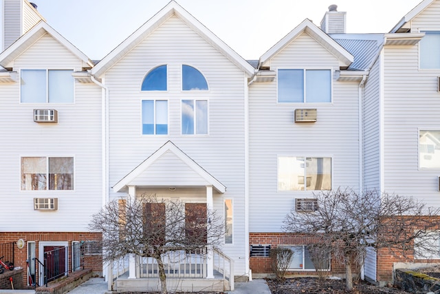 townhome / multi-family property featuring central air condition unit and a chimney