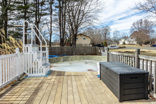 wooden deck with a residential view and a fenced backyard